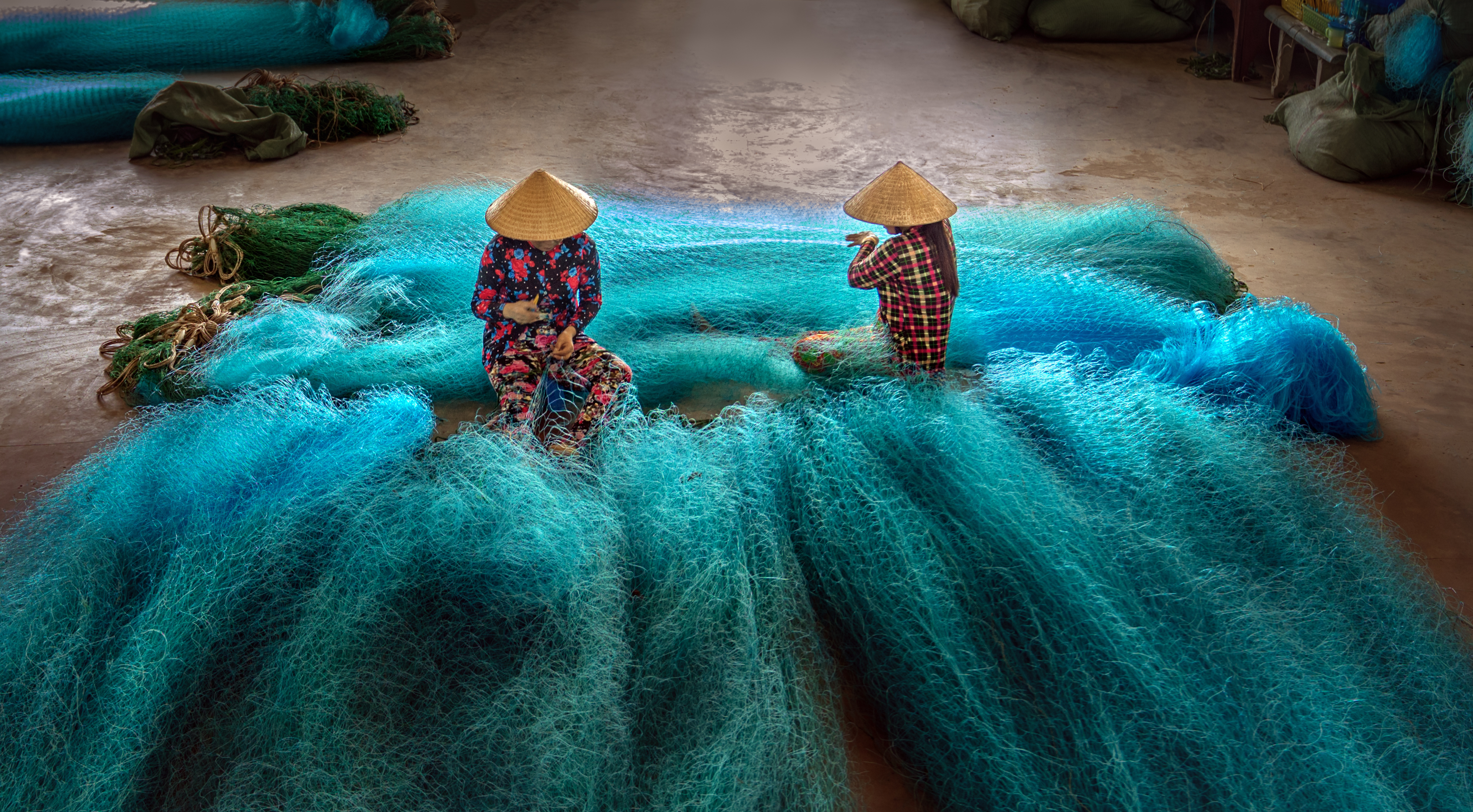 Vietnamese women are repairing fishing nets in a repair shop. Although women are engaged at all levels of interactions with the ocean, gender inequality is not uncommon across sectors.