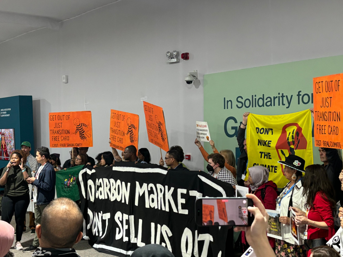 Civil society organizations protest against carbon markets inside the COP venue.