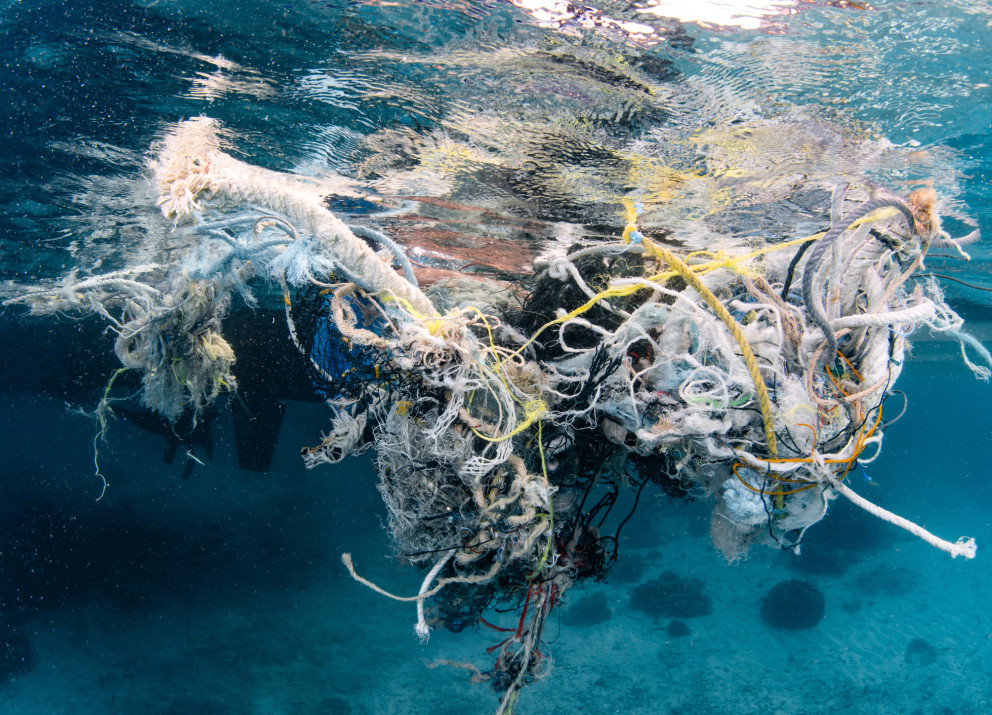 Abandoned fishing net and plastic waste in the ocean