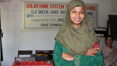 A trainee in Bangladesh learns how to maintain solar panels. Her training was organised by the International Labour Organisation (ILO), a specialised agency of the United Nations. 