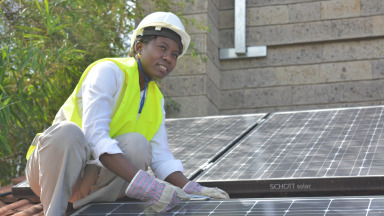 A student installing solar panels.