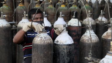 Covid_19, India, worker fills medical oxygen cylinders for patients with Covid-19 infections